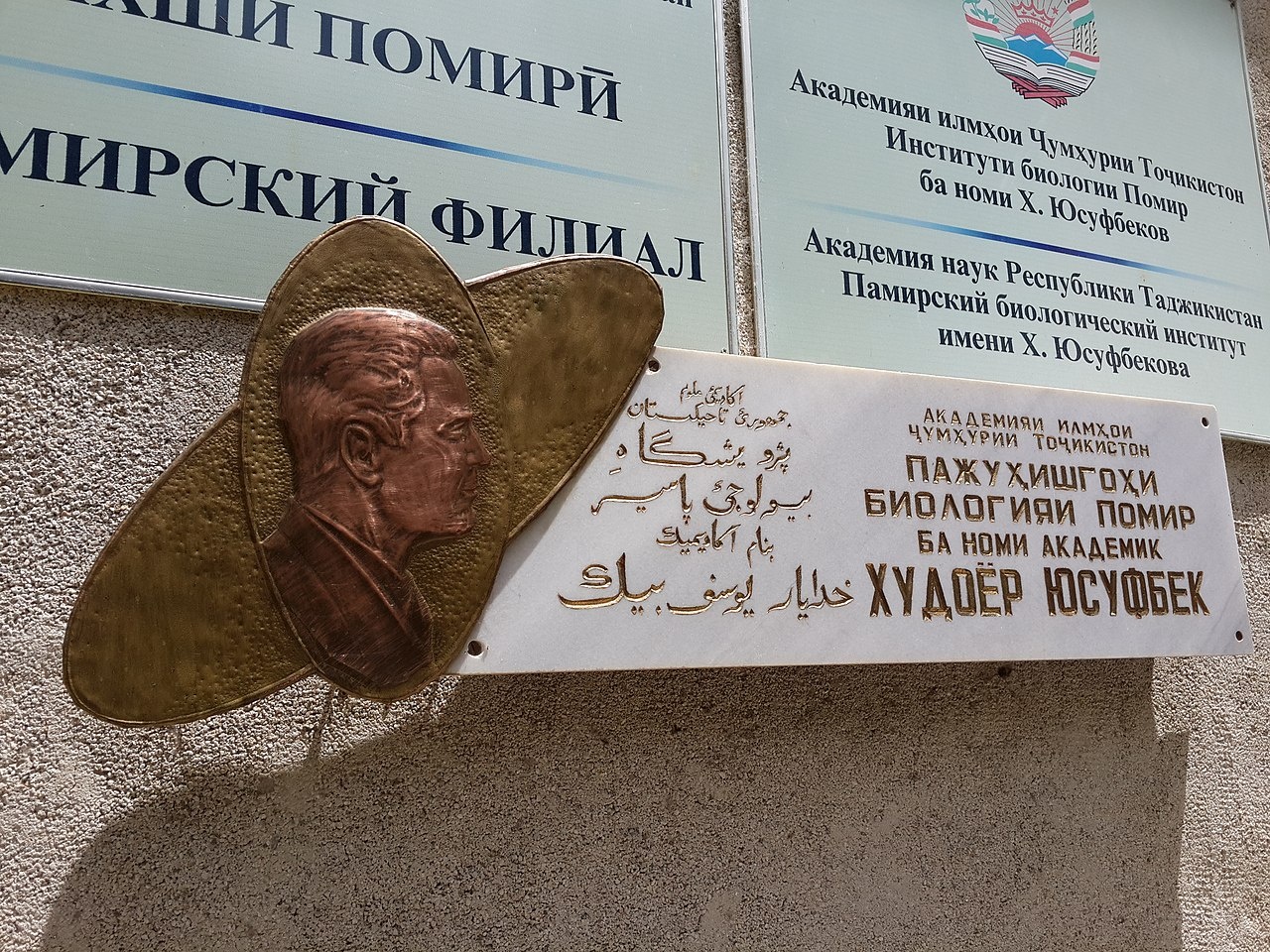 Плита с рельефным изображением академика Х.Ю. Юсуфбекова на фасаде здания Памирского биологического института.